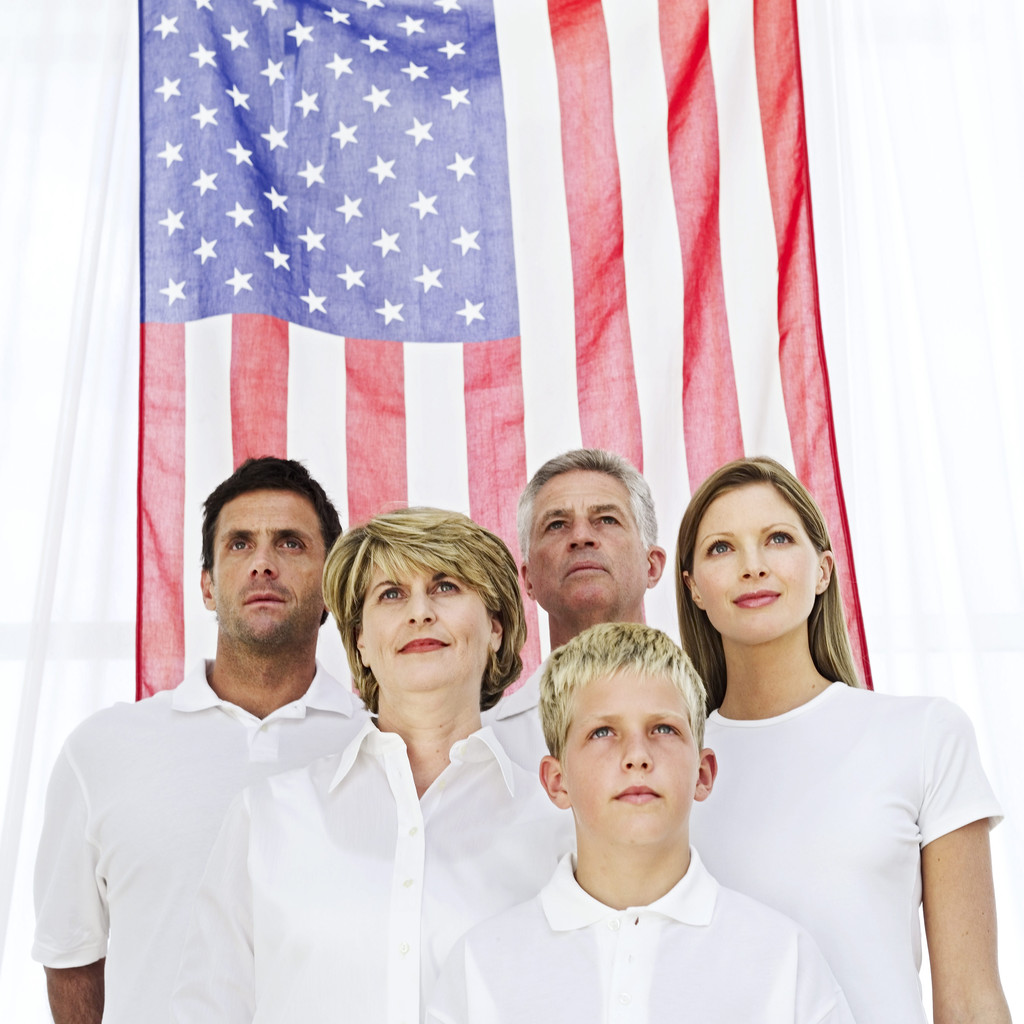 Family Standing in Front of the American Flag